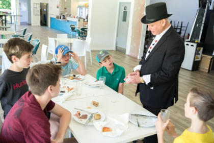 Adelaide Magician George performing close up magic for some younger people